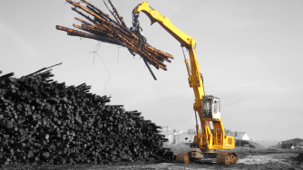 Rotobec log grapple taking several logs very high in the air with a log loader.