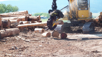 Rotobec log grapple with a saw sawing a log.
