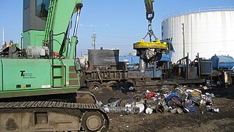 A scrap handling magnet lifting scrap.